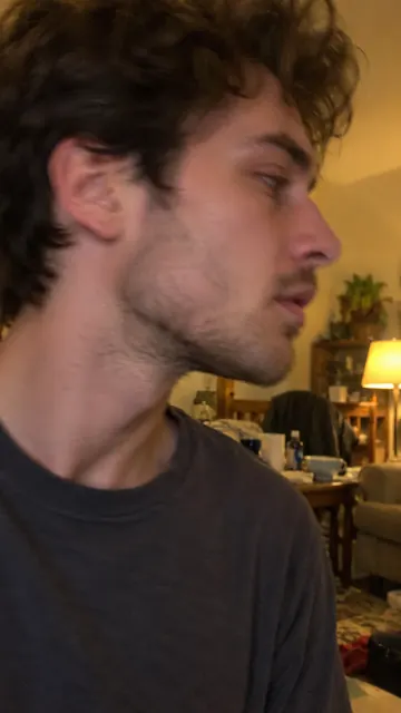 A close side view of a man with the top of his head cut off